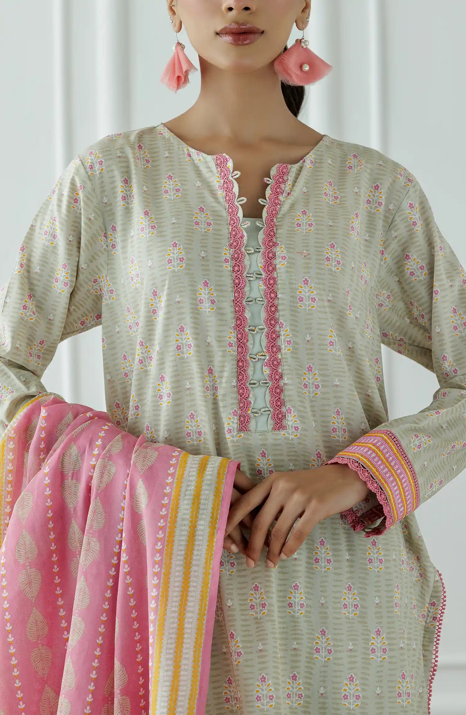 Stitched Printed Lawn Shirt Dupatta & Pant - 3 Piece - OTL-25-019. Woman wearing a traditional outfit with a white and pink patterned dress against a plain background