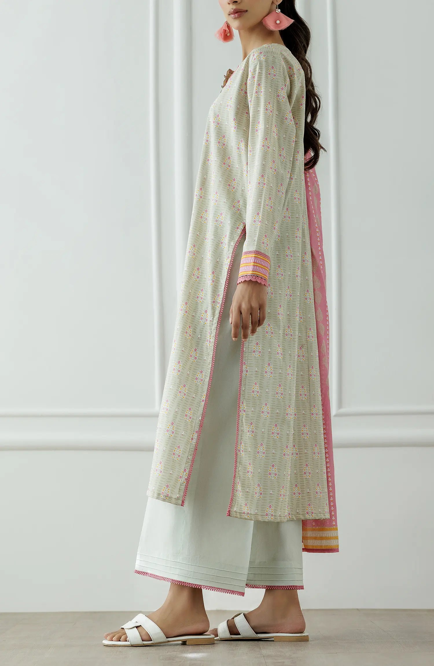 Stitched Printed Lawn Shirt Dupatta & Pant - 3 Piece - OTL-25-019. Woman wearing a traditional outfit with a white and pink patterned dress against a plain background