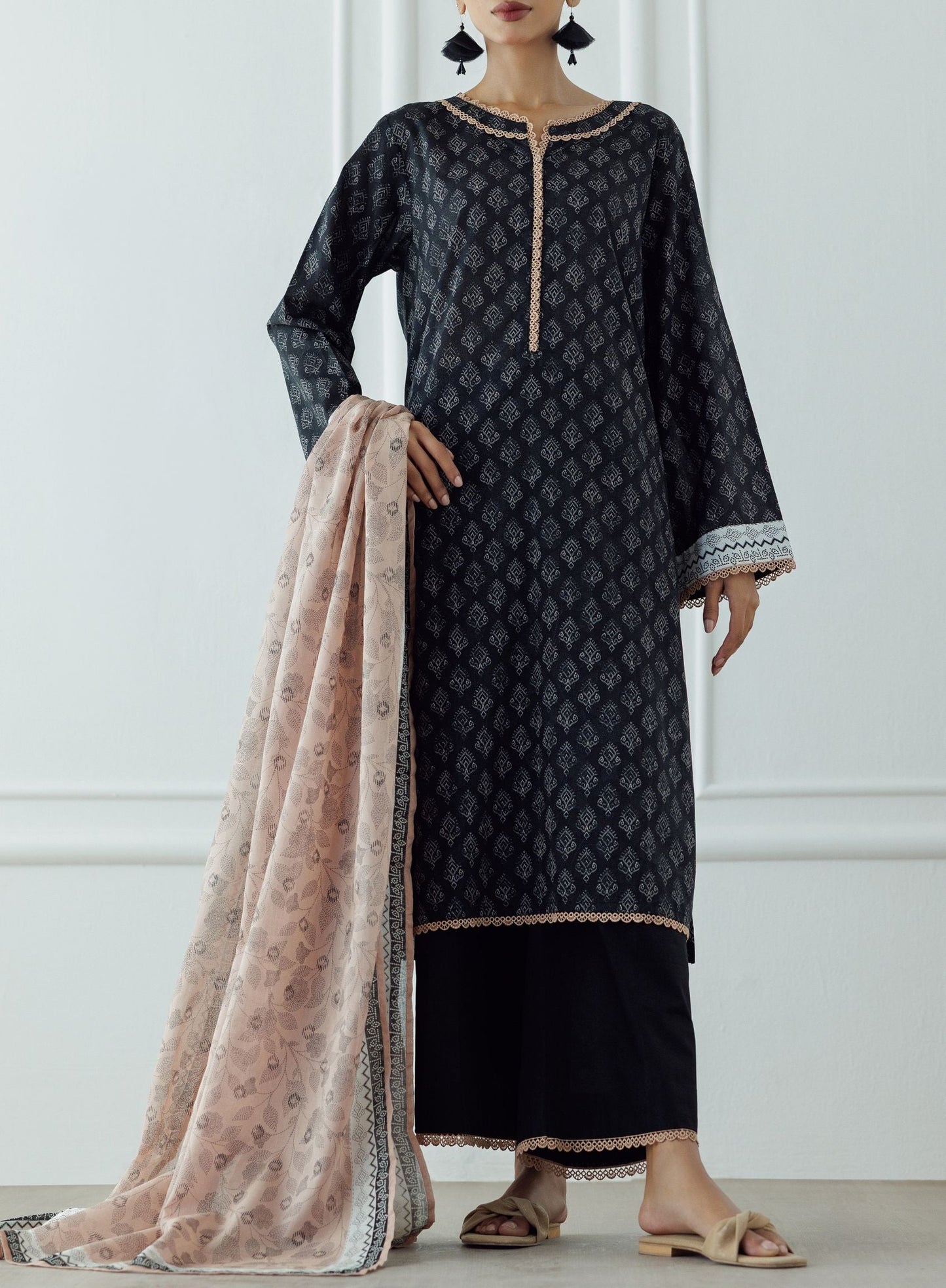 Stitched Printed Lawn Shirt Dupatta & Pant - 3 Piece - OTL-25-023. Woman wearing a black patterned kurta with a matching dupatta against a white background