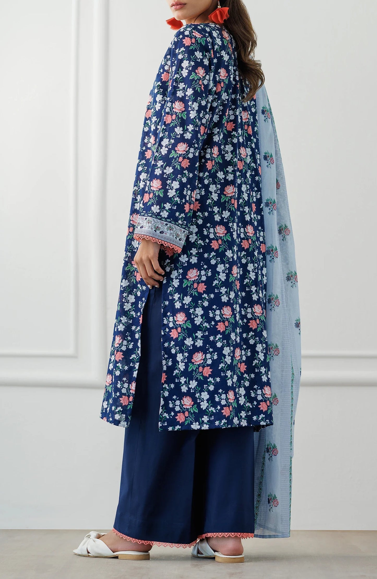 Woman wearing a blue floral kurta with matching pants and a light blue dupatta with dyed trouser. Unstitched Printed Lawn Shirt Dupatta & Pant - 3 Piece Suits - OTL-25-028