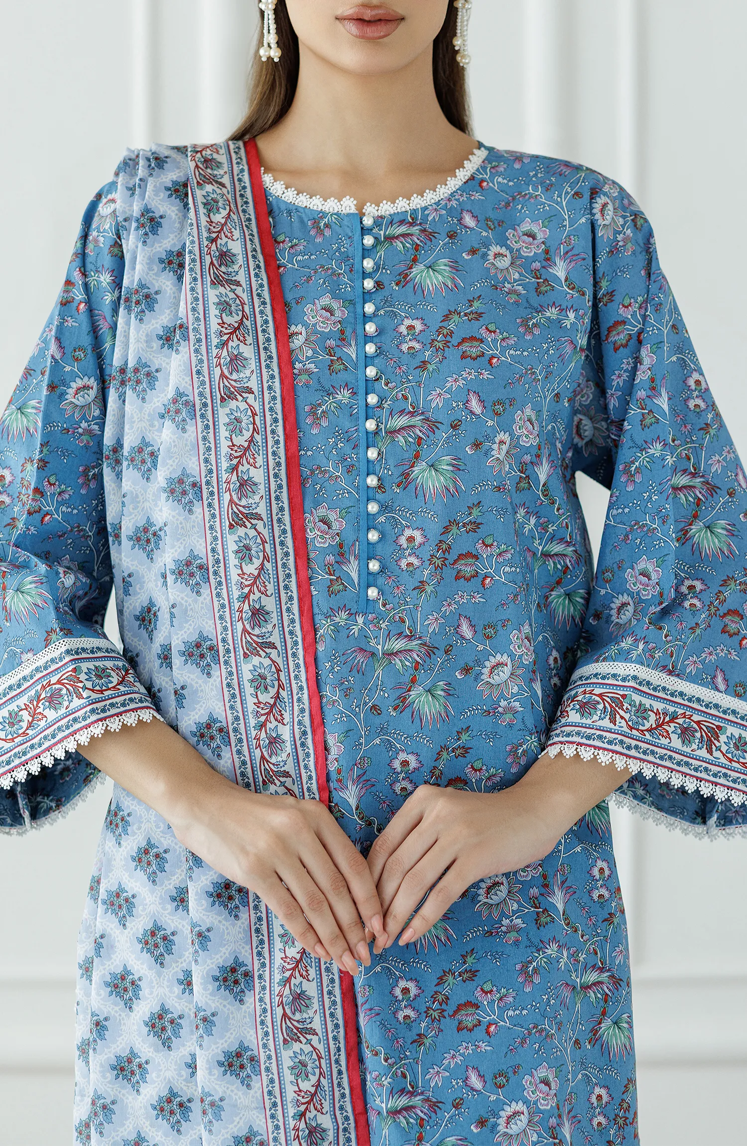 Woman wearing a blue traditional outfit with a dyed shalwar. Stitched Printed Lawn Shirt Dupatta & Pant - 3 Piece - OTL-25-333.