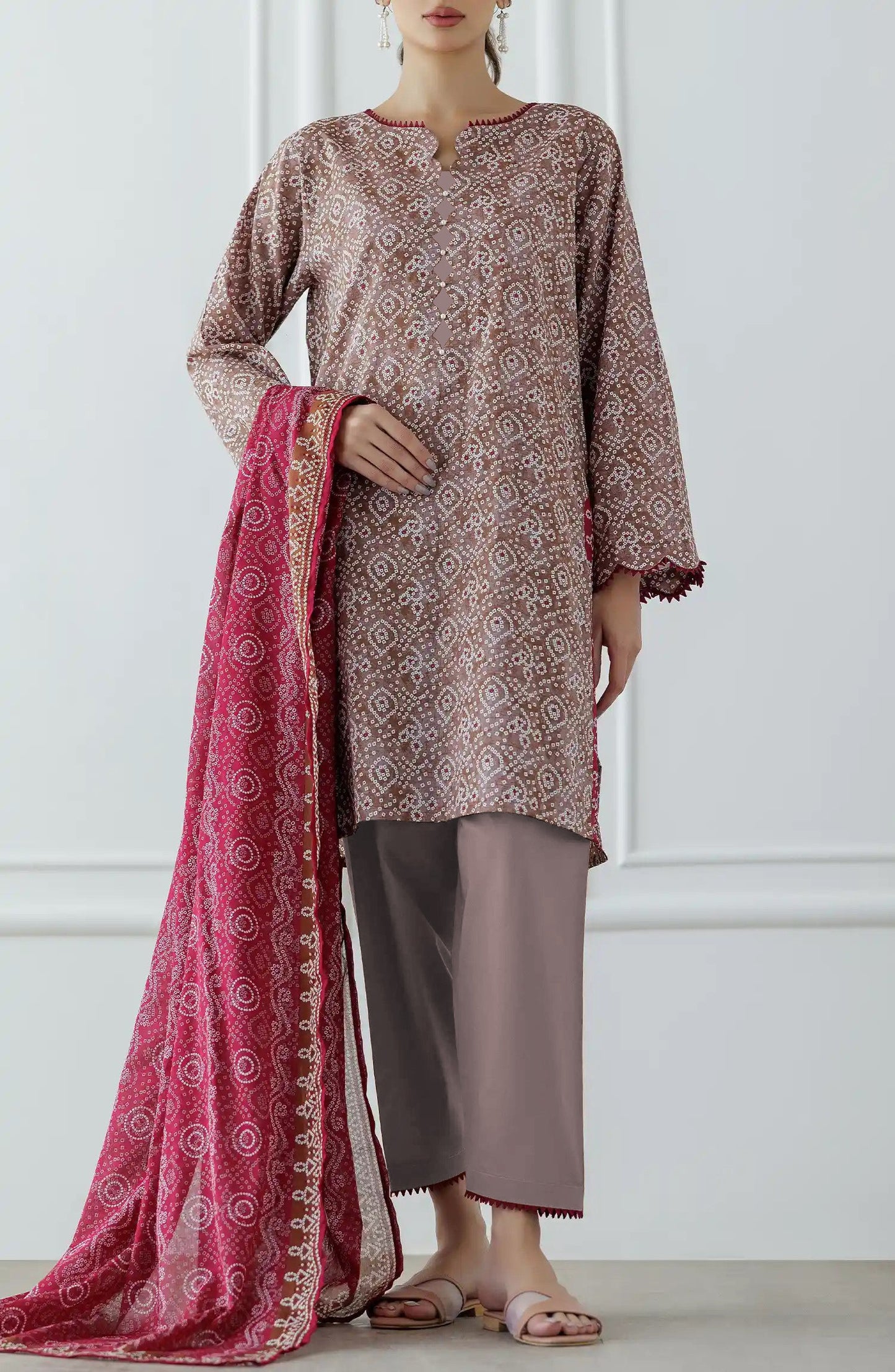 Woman wearing a patterned kurta with pants and a pink dupatta against a dyed trouser. Stitched Printed Lawn Shirt Dupatta & Pant - 3 Piece - OTL-25-308.