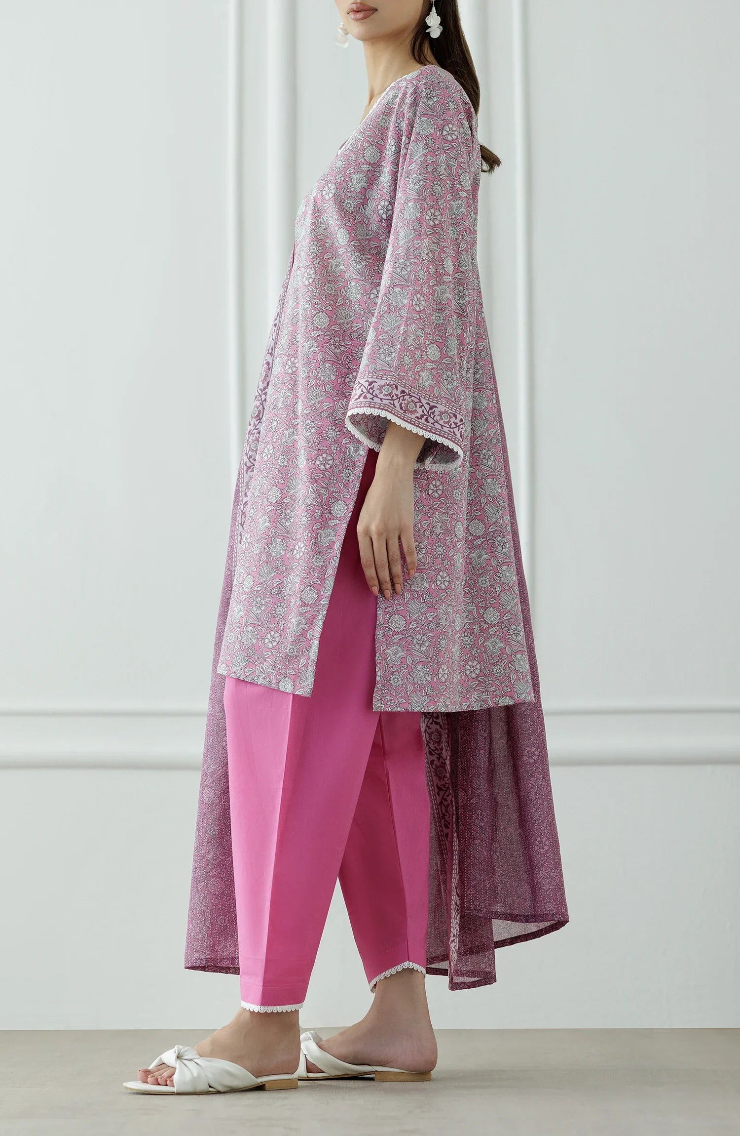 Woman wearing a pink traditional outfit with a matching dupatta against a matching traditional shalwar. Stitched Printed Lawn Shirt Dupatta & Pant - 3 Piece - OTL-25-309.