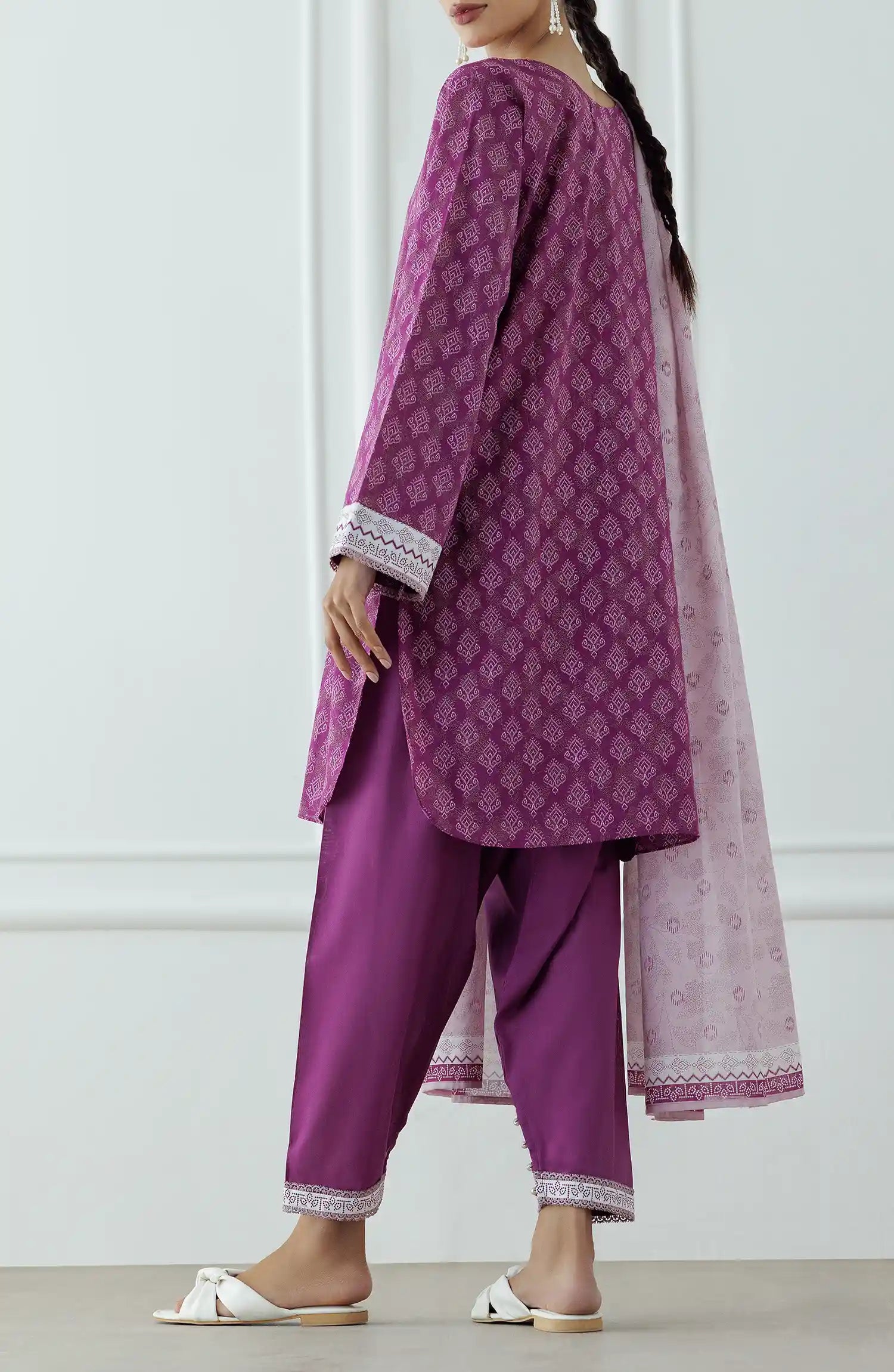 Stitched Printed Lawn Shirt Dupatta & Pant - 3 Piece - OTL-25-314. Woman wearing a patterned dress with a matching dupatta. Woman wearing a purple traditional outfit with a matching dupatta and dyed shalwar.