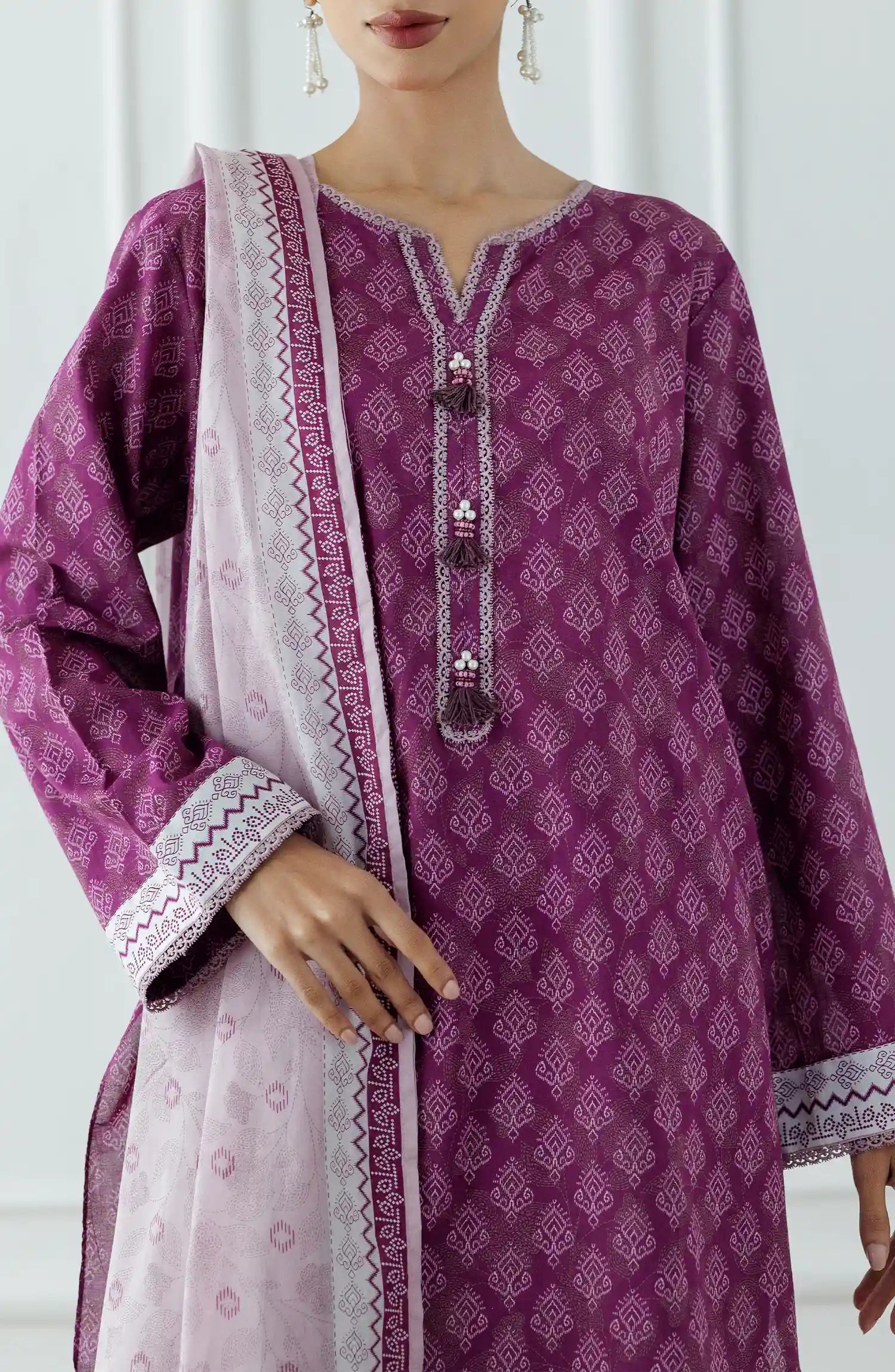 Stitched Printed Lawn Shirt Dupatta & Pant - 3 Piece - OTL-25-314. Woman wearing a patterned dress with a matching dupatta. Woman wearing a purple traditional outfit with a matching dupatta and dyed shalwar.