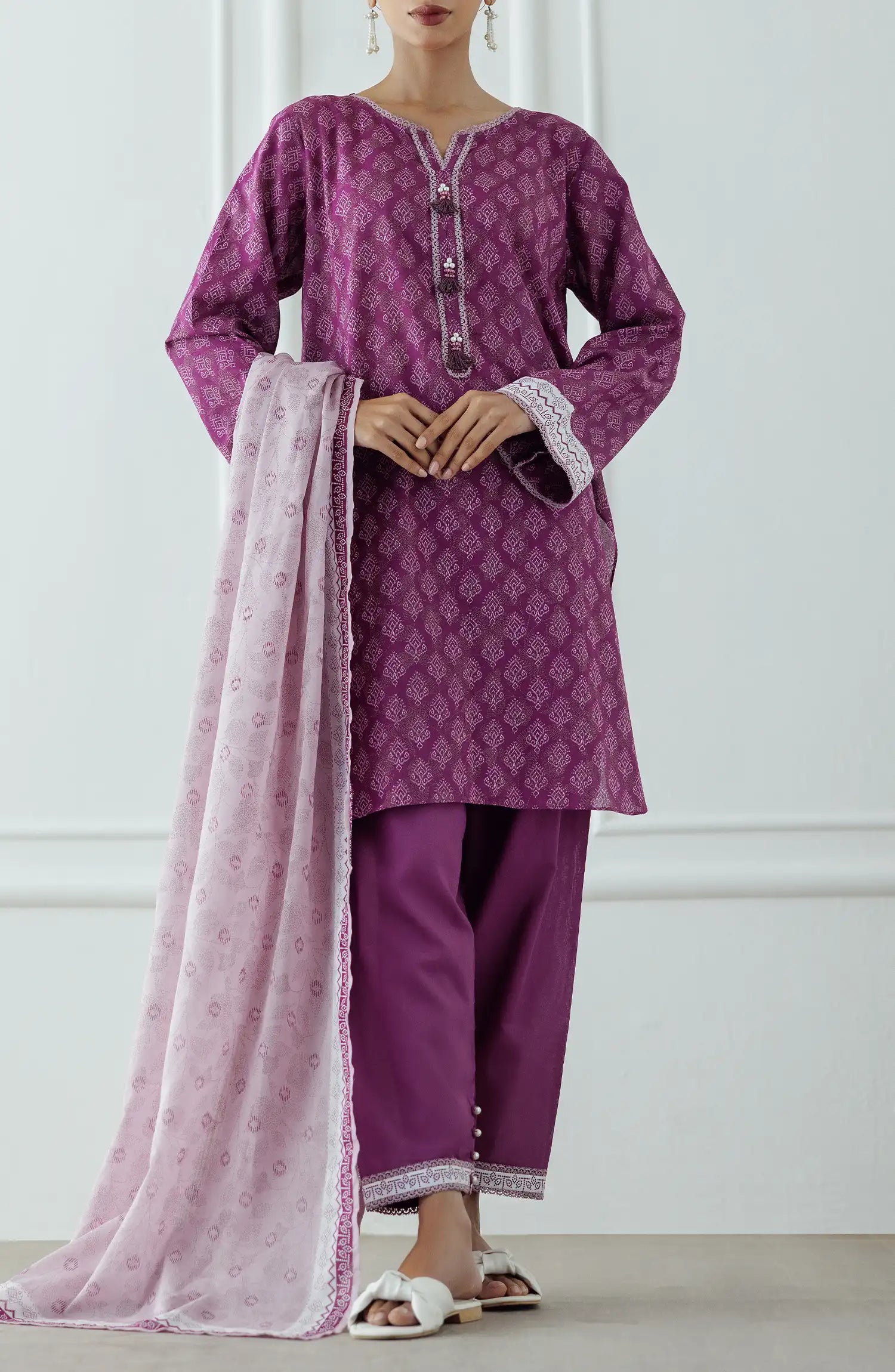 Stitched Printed Lawn Shirt Dupatta & Pant - 3 Piece - OTL-25-314. Woman wearing a patterned dress with a matching dupatta. Woman wearing a purple traditional outfit with a matching dupatta and dyed shalwar.