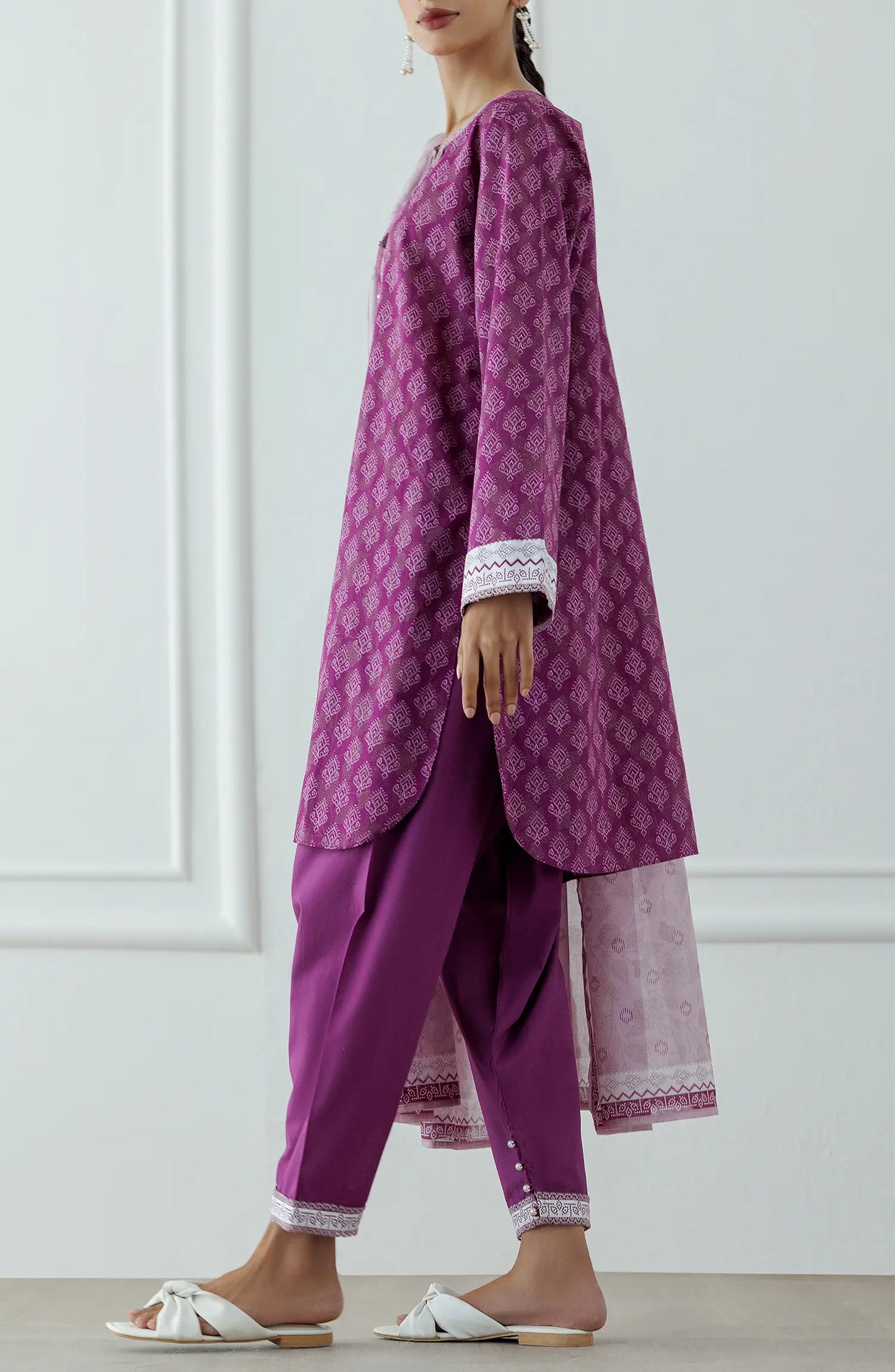 Stitched Printed Lawn Shirt Dupatta & Pant - 3 Piece - OTL-25-314. Woman wearing a patterned dress with a matching dupatta. Woman wearing a purple traditional outfit with a matching dupatta and dyed shalwar.