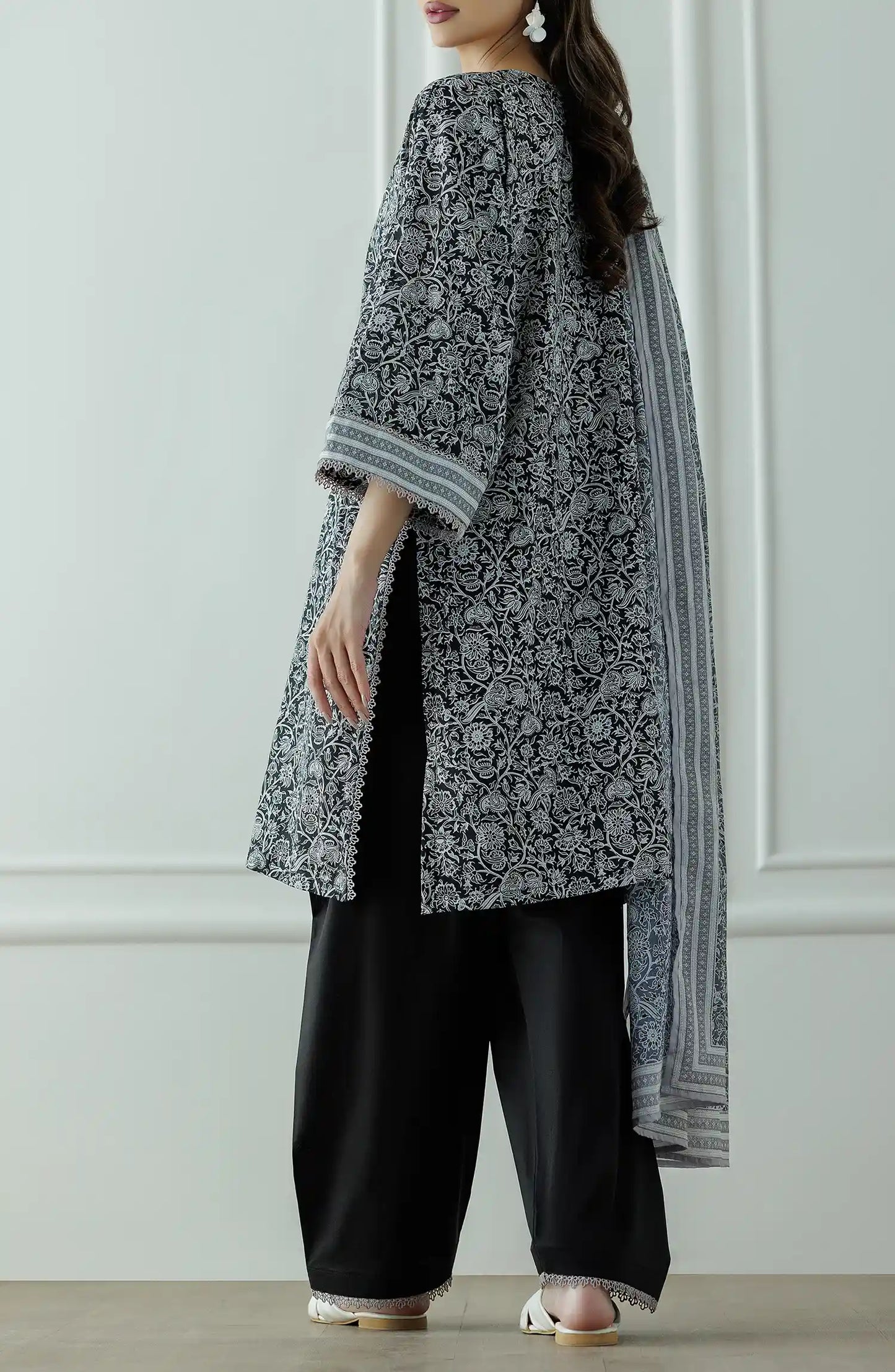 Stitched Printed Lawn Shirt Dupatta & Pant - 3 Piece - OTL-25-331. Woman wearing a black and white patterned kurta with black pants and a long black and white dupatta and black trouser.