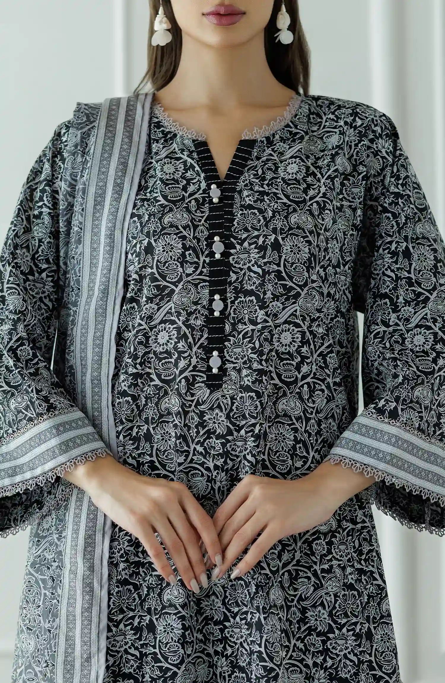Stitched Printed Lawn Shirt Dupatta & Pant - 3 Piece - OTL-25-331. Woman wearing a black and white patterned kurta with black pants and a long black and white dupatta and black trouser.