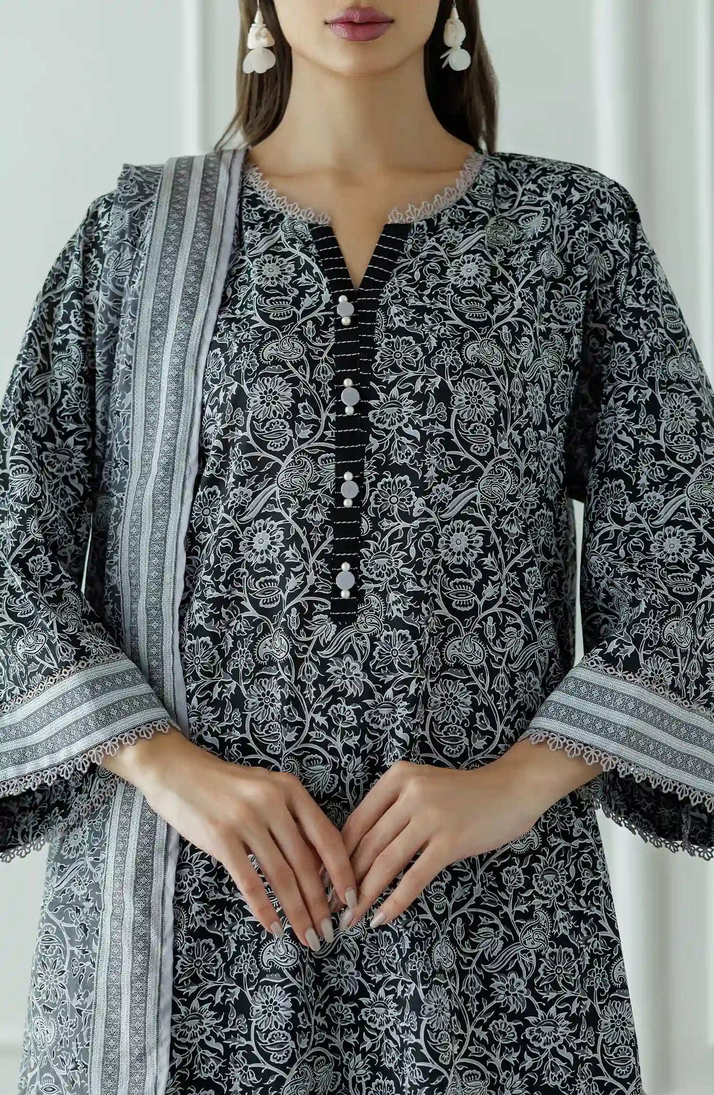 Stitched Printed Lawn Shirt Dupatta & Pant - 3 Piece - OTL-25-331. Woman wearing a black and white patterned kurta with black pants and a long black and white dupatta and black trouser.