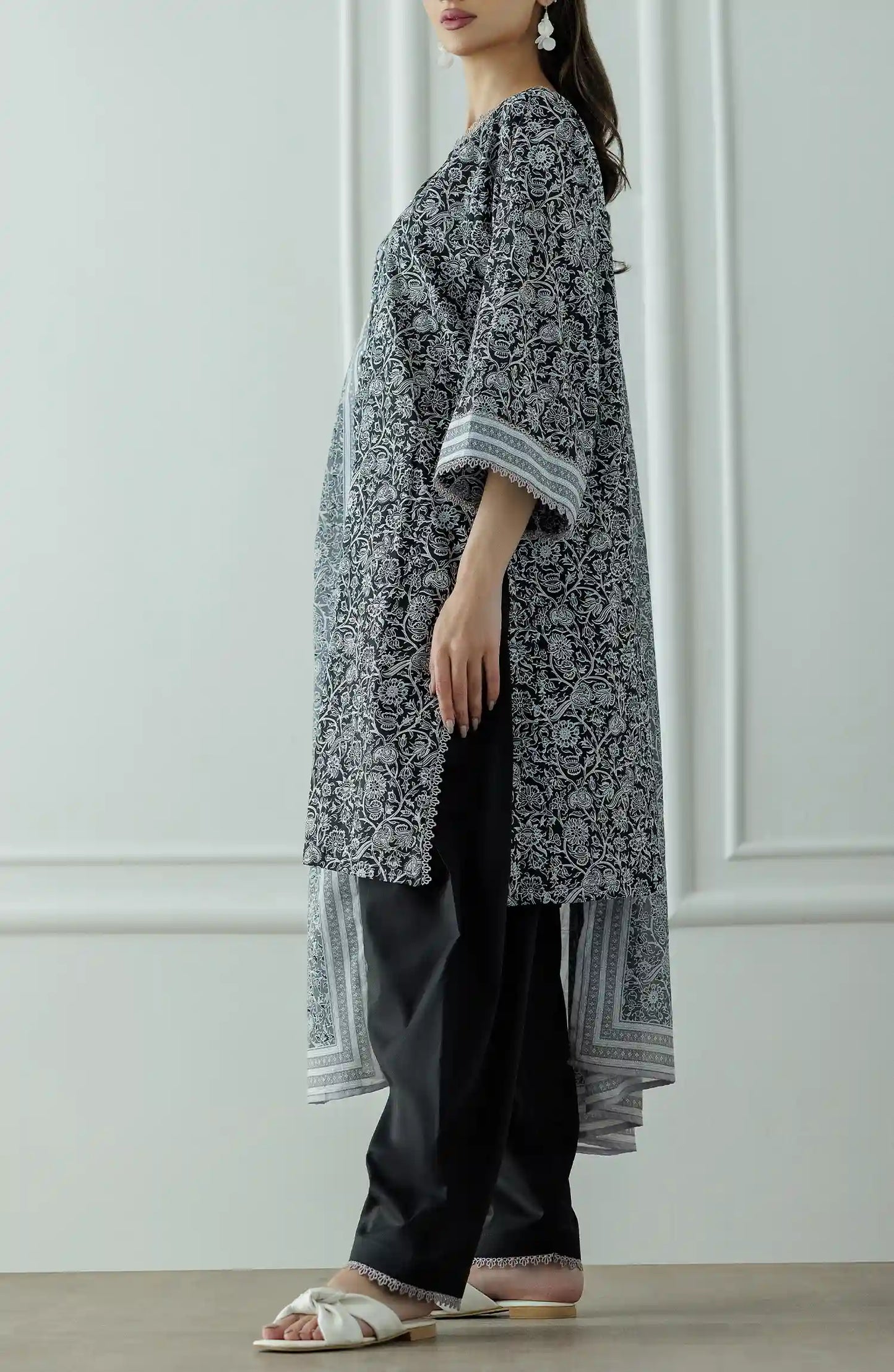 Stitched Printed Lawn Shirt Dupatta & Pant - 3 Piece - OTL-25-331. Woman wearing a black and white patterned kurta with black pants and a long black and white dupatta and black trouser.