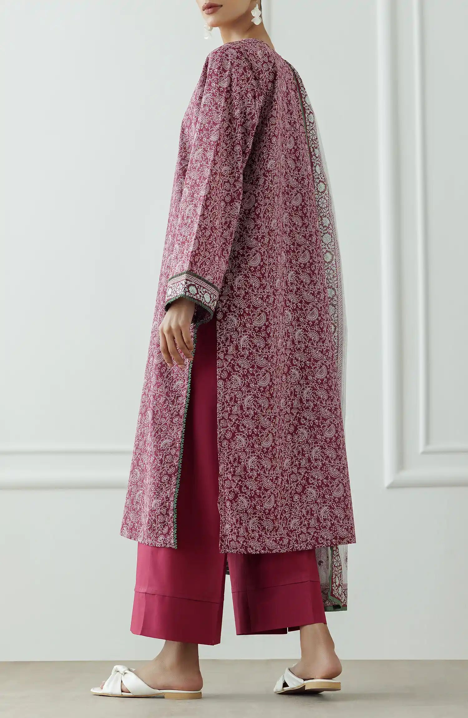 Woman wearing a pink floral kurta with white pants and a matching dupatta against a plain dyed trouser. Stitched Printed Lawn Shirt Dupatta & Pant - 3 Piece - OTL-25-333.