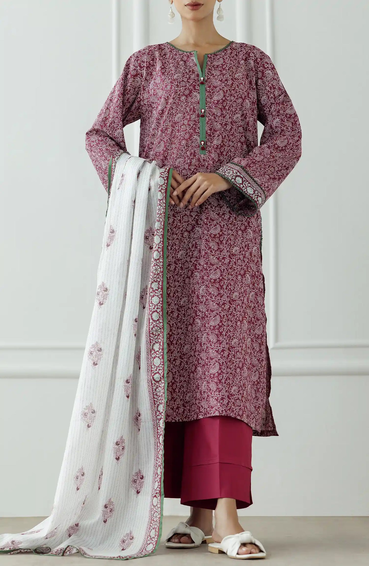 Woman wearing a pink floral kurta with white pants and a matching dupatta against a plain dyed trouser. Stitched Printed Lawn Shirt Dupatta & Pant - 3 Piece - OTL-25-333.