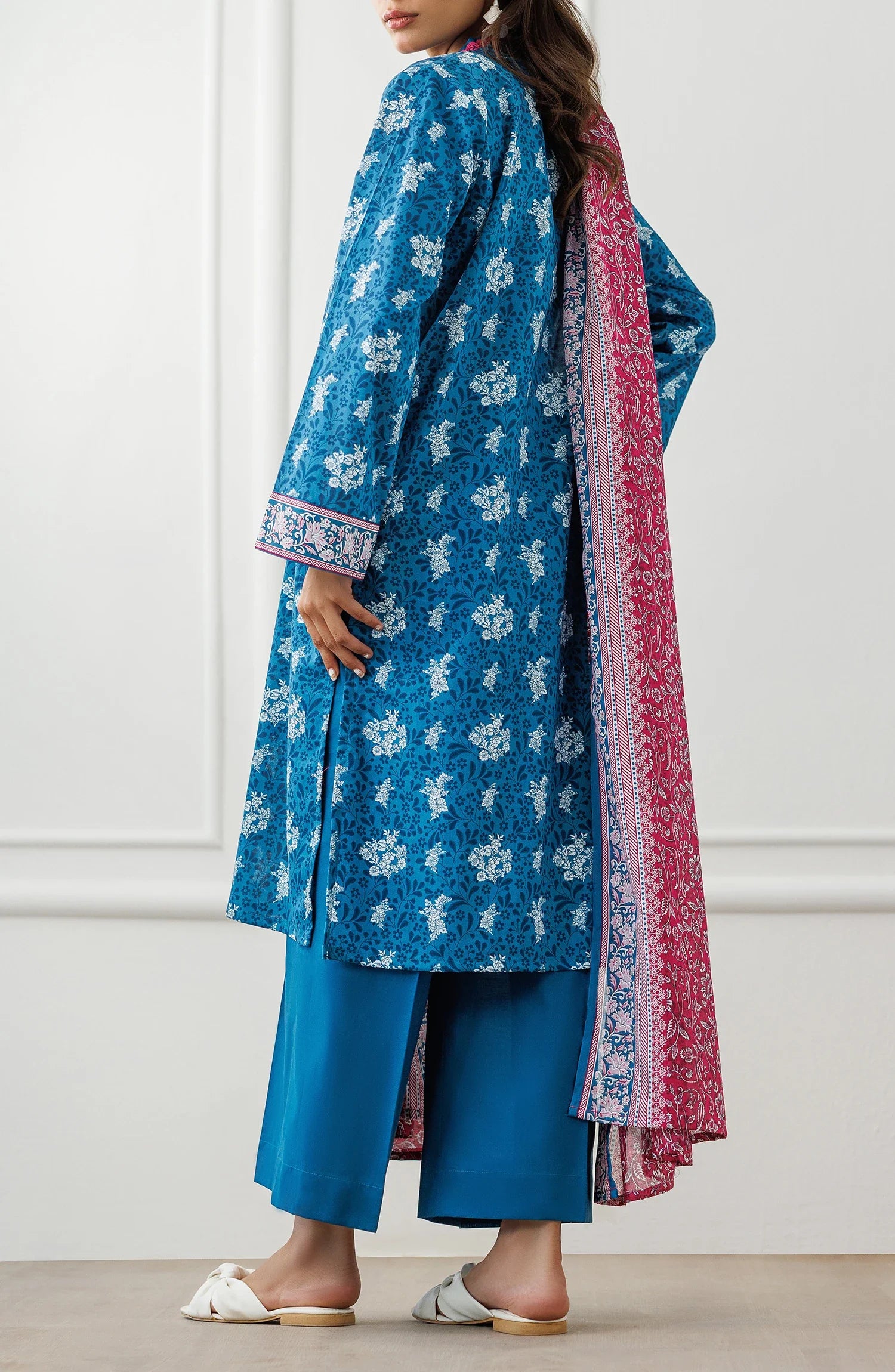 Woman wearing a blue floral dress with a pink dupatta against a matching trouser. Unstitched Printed Lawn Shirt Dupatta & Pant - 3 Piece Suits - OTL-25-477