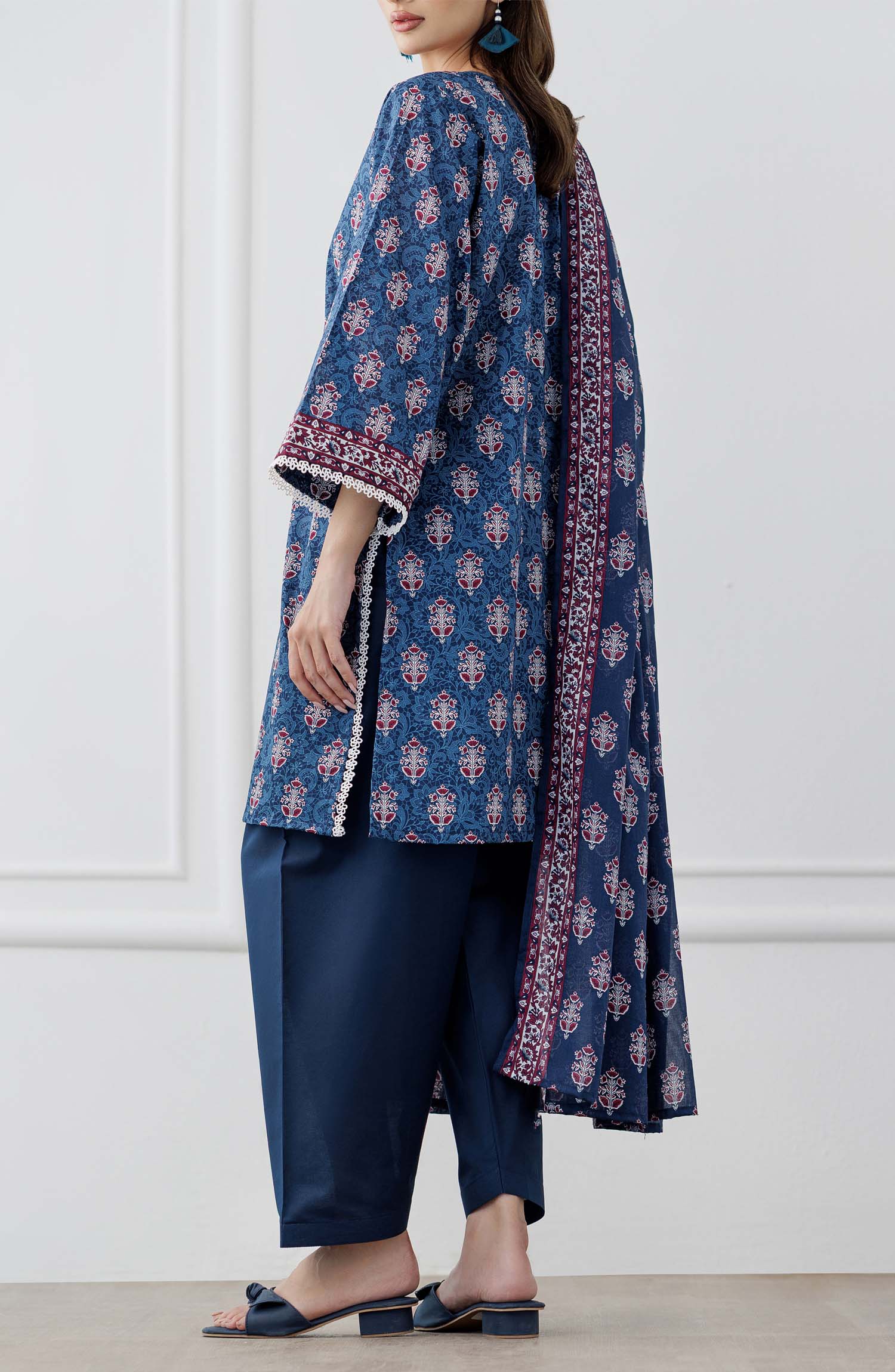 UNSTITCHED Printed Lawn Shirt Dupatta & Pant - 3 Piece Suits - OTL-25-353. Woman wearing a blue patterned kurta with matching pants and a dupatta against a plain trouser.