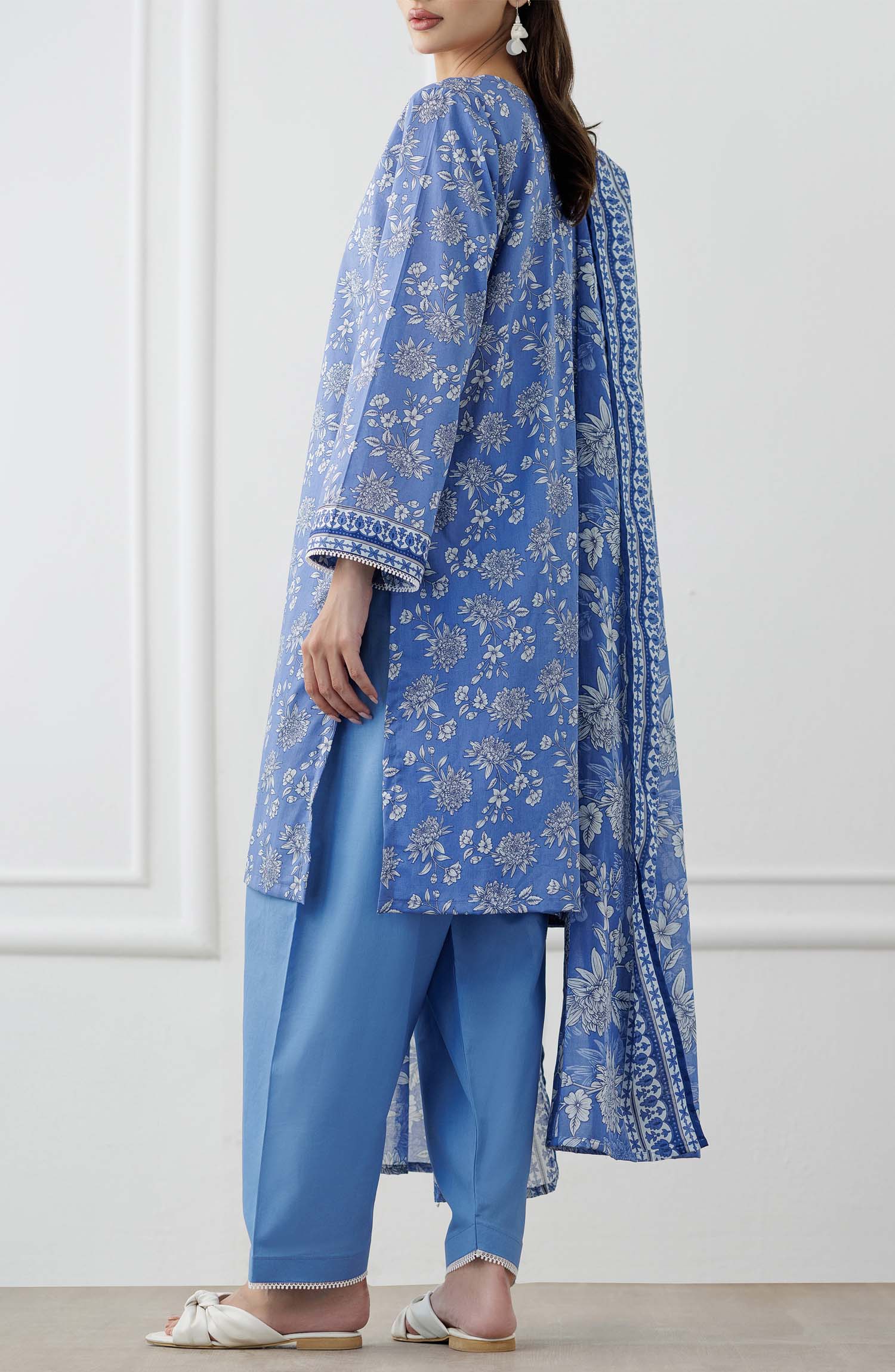 UNSTITCHED Printed Lawn Shirt Dupatta & Pant - 3 Piece Suits - OTL-25-338. Woman wearing a blue floral outfit with a matching dupatta and dyed trouser.