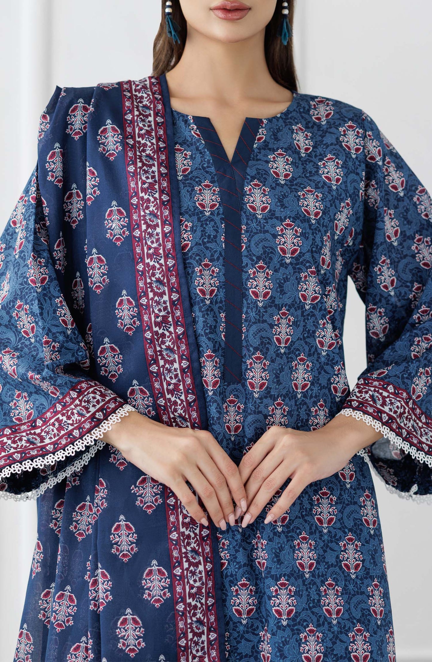 UNSTITCHED Printed Lawn Shirt Dupatta & Pant - 3 Piece Suits - OTL-25-353. Woman wearing a blue patterned kurta with matching pants and a dupatta against a plain trouser.