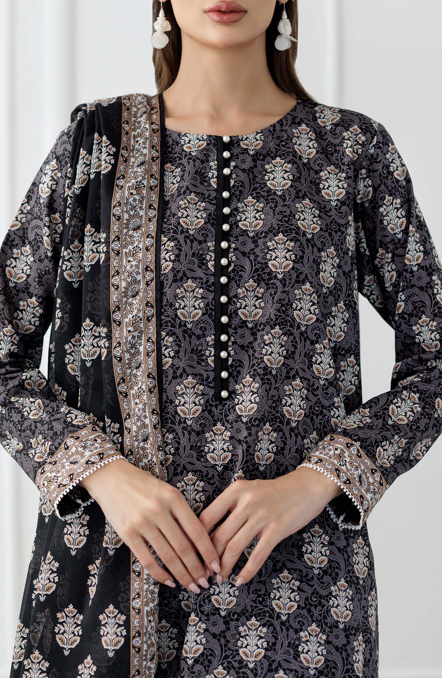 UNSTITCHED Printed Lawn Shirt Dupatta & Pant - 3 Piece Suits - OTL-25-105. Woman wearing a black and white patterned kurta with a matching dupatta in a minimalistic setting and plain trouser.