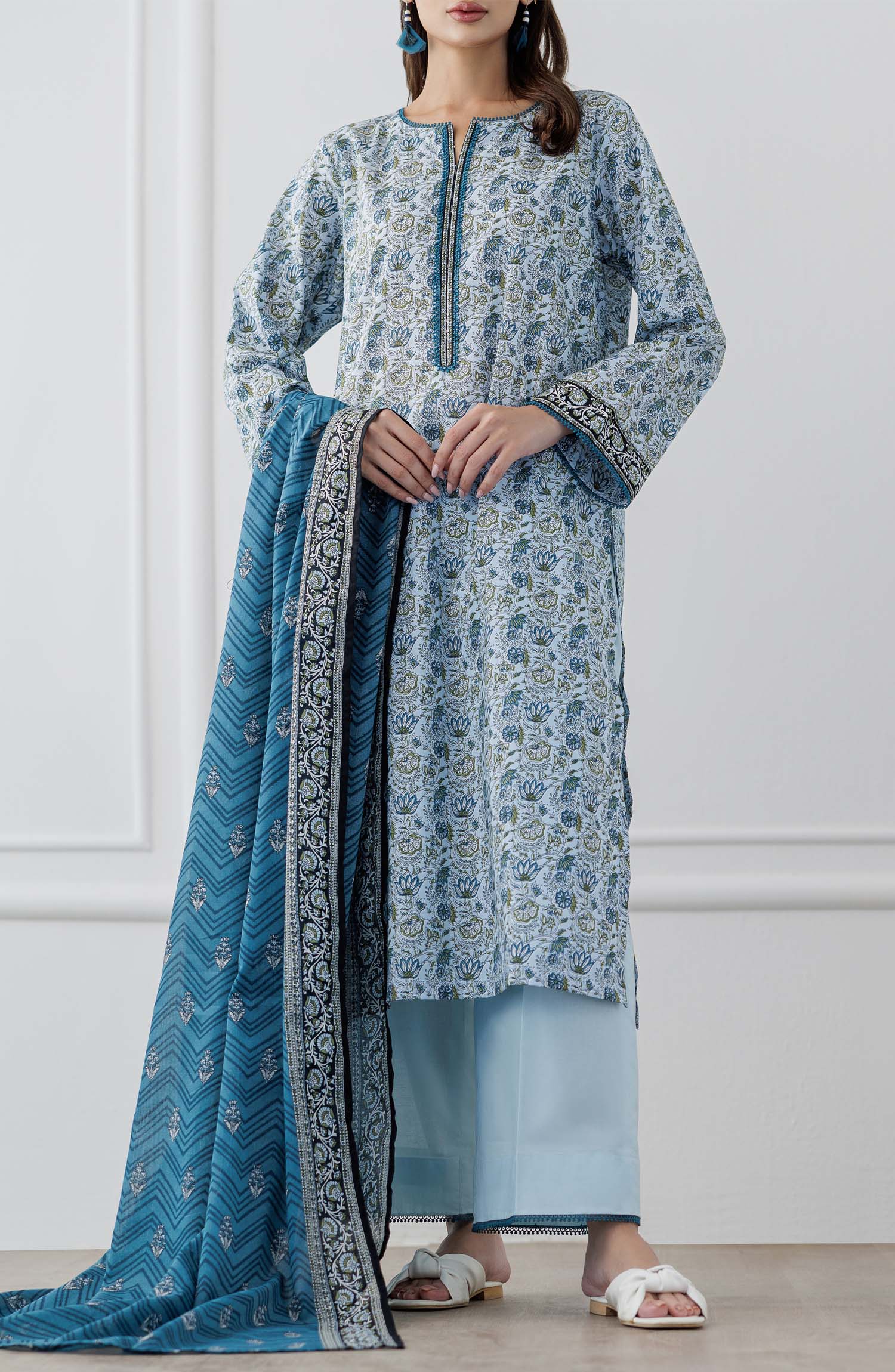 UNSTITCHED Printed Lawn Shirt Dupatta & Pant - 3 Piece Suits - OTL-25-347. Woman wearing a blue and white patterned kurta with a matching dupatta and dyed trouser.