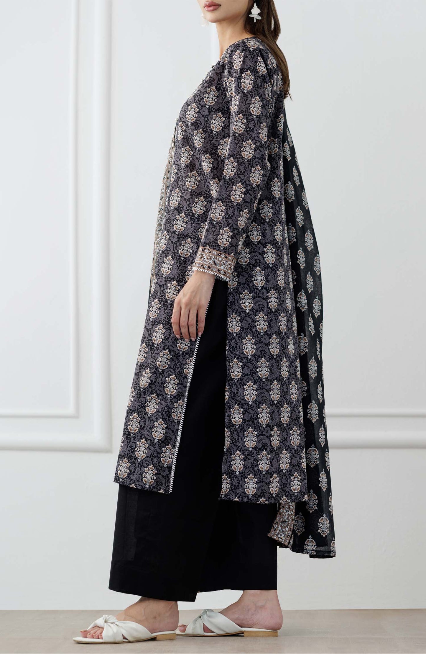 UNSTITCHED Printed Lawn Shirt Dupatta & Pant - 3 Piece Suits - OTL-25-105. Woman wearing a black and white patterned kurta with a matching dupatta in a minimalistic setting and plain trouser.