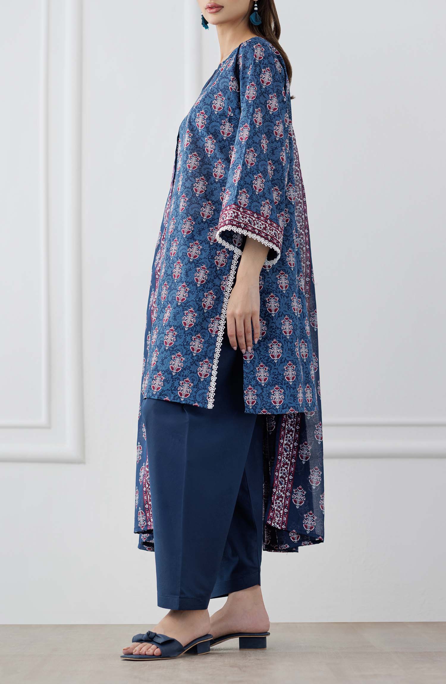 UNSTITCHED Printed Lawn Shirt Dupatta & Pant - 3 Piece Suits - OTL-25-353. Woman wearing a blue patterned kurta with matching pants and a dupatta against a plain trouser.