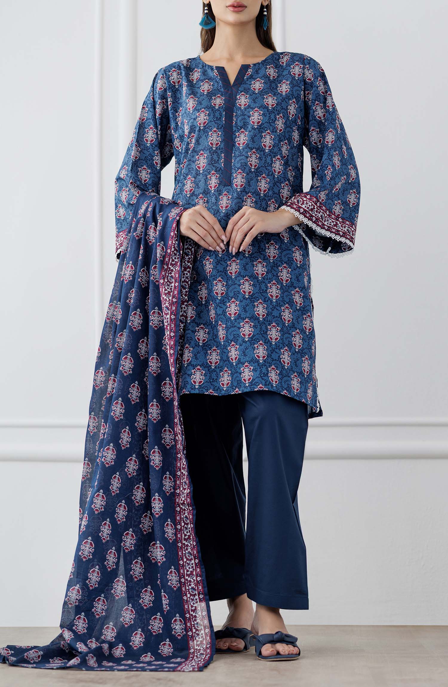 UNSTITCHED Printed Lawn Shirt Dupatta & Pant - 3 Piece Suits - OTL-25-353. Woman wearing a blue patterned kurta with matching pants and a dupatta against a plain trouser.