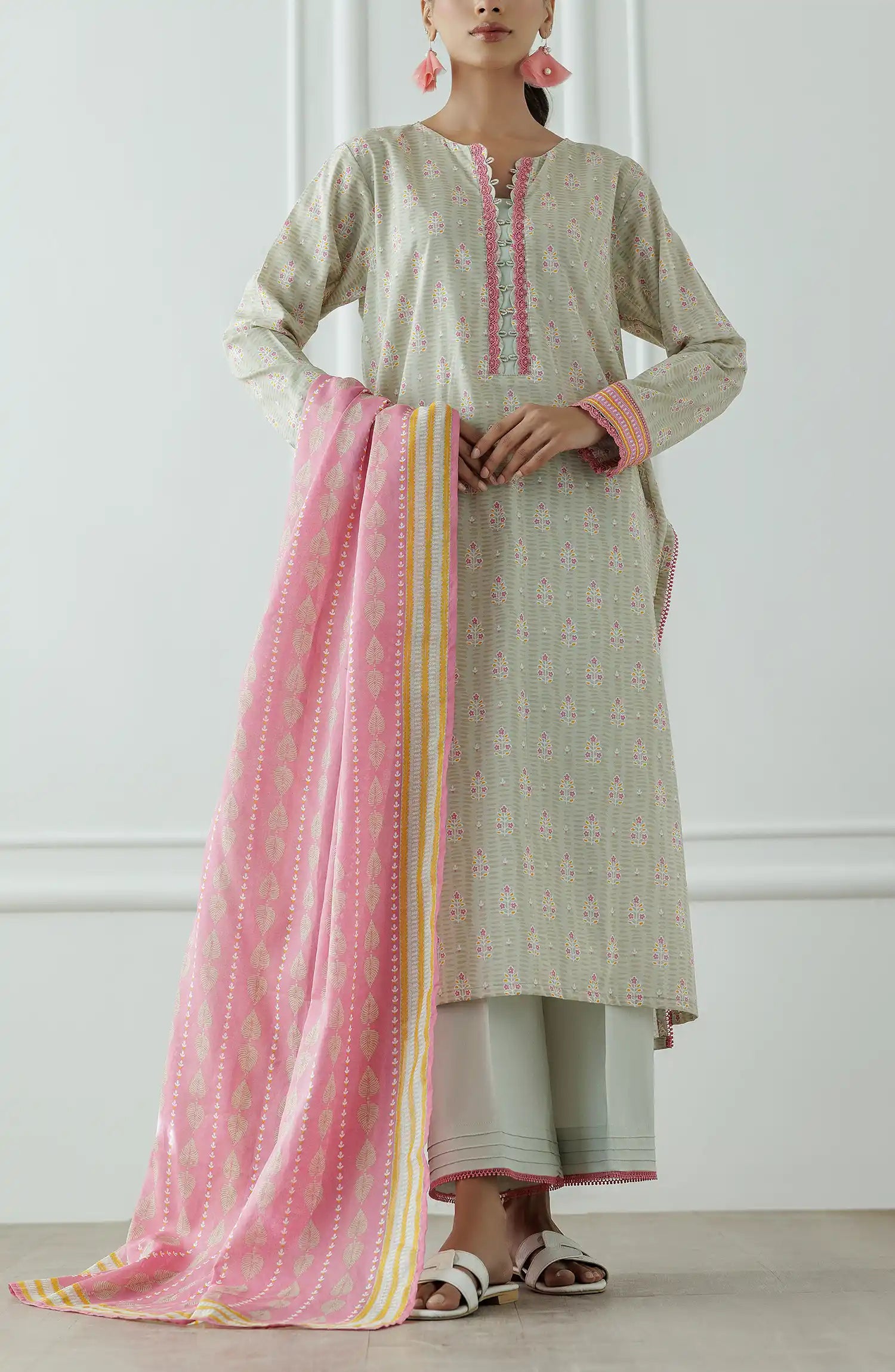 Stitched Printed Lawn Shirt Dupatta & Pant - 3 Piece - OTL-25-019. Woman wearing a traditional outfit with a white and pink patterned dress against a plain background