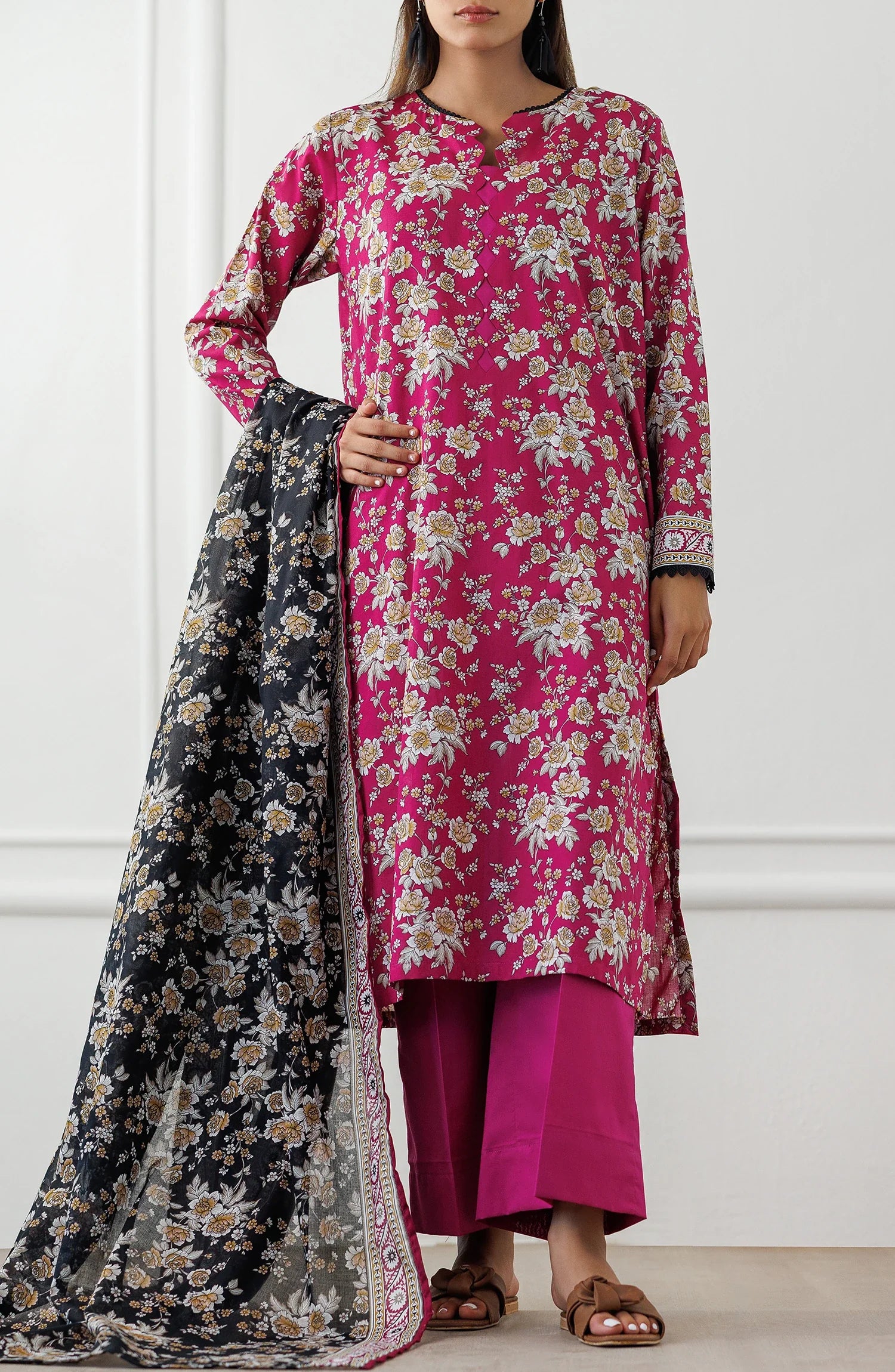 Woman wearing a pink floral kurta with matching pants and a black floral dupatta on a dyed plain trouser. Unstitched Printed Lawn Shirt Dupatta & Pant - 3 Piece Suits - OTL-25-346