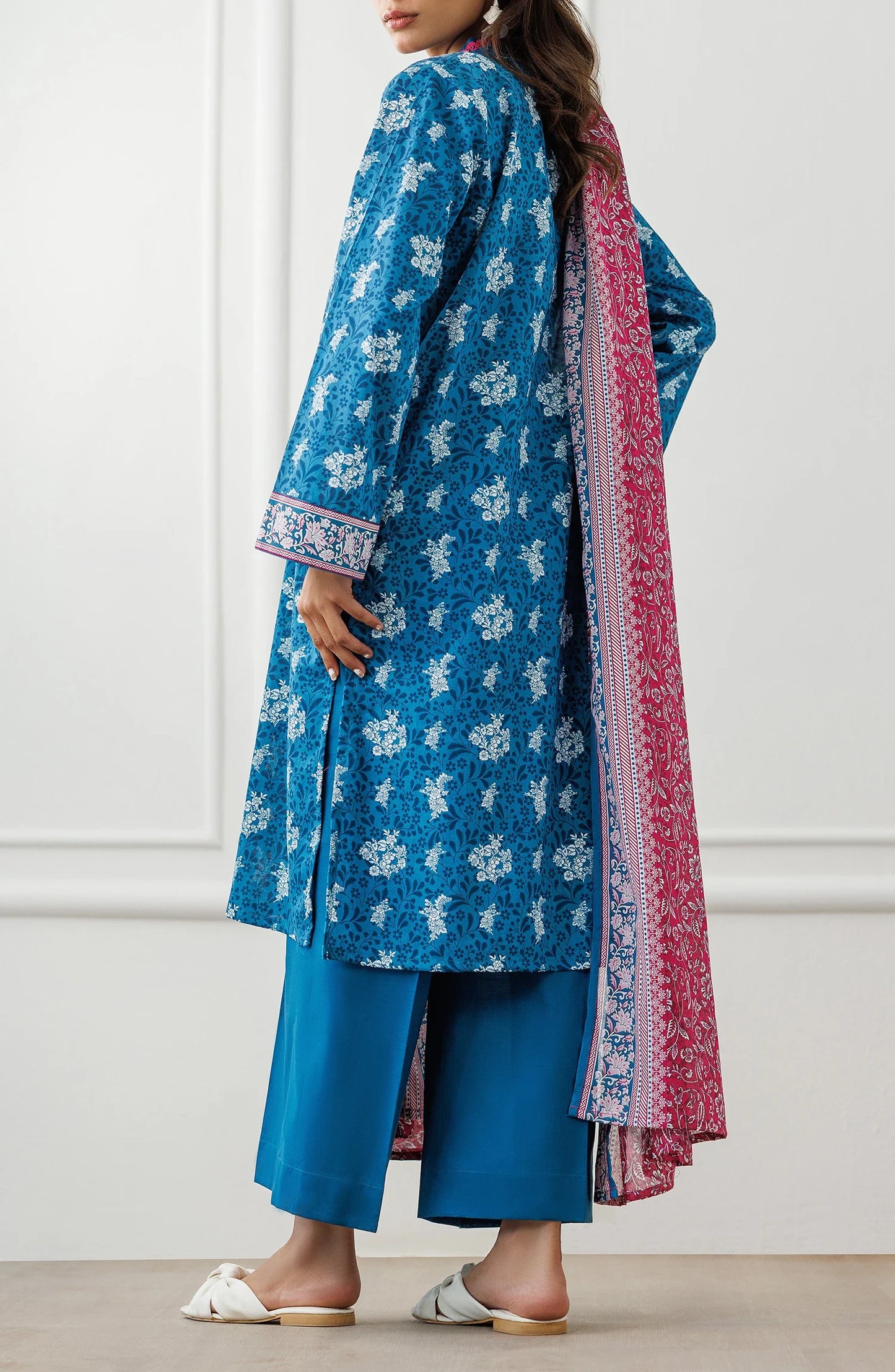 Woman wearing a blue floral dress with a pink dupatta against a matching trouser. Unstitched Printed Lawn Shirt Dupatta & Pant - 3 Piece Suits - OTL-25-477
